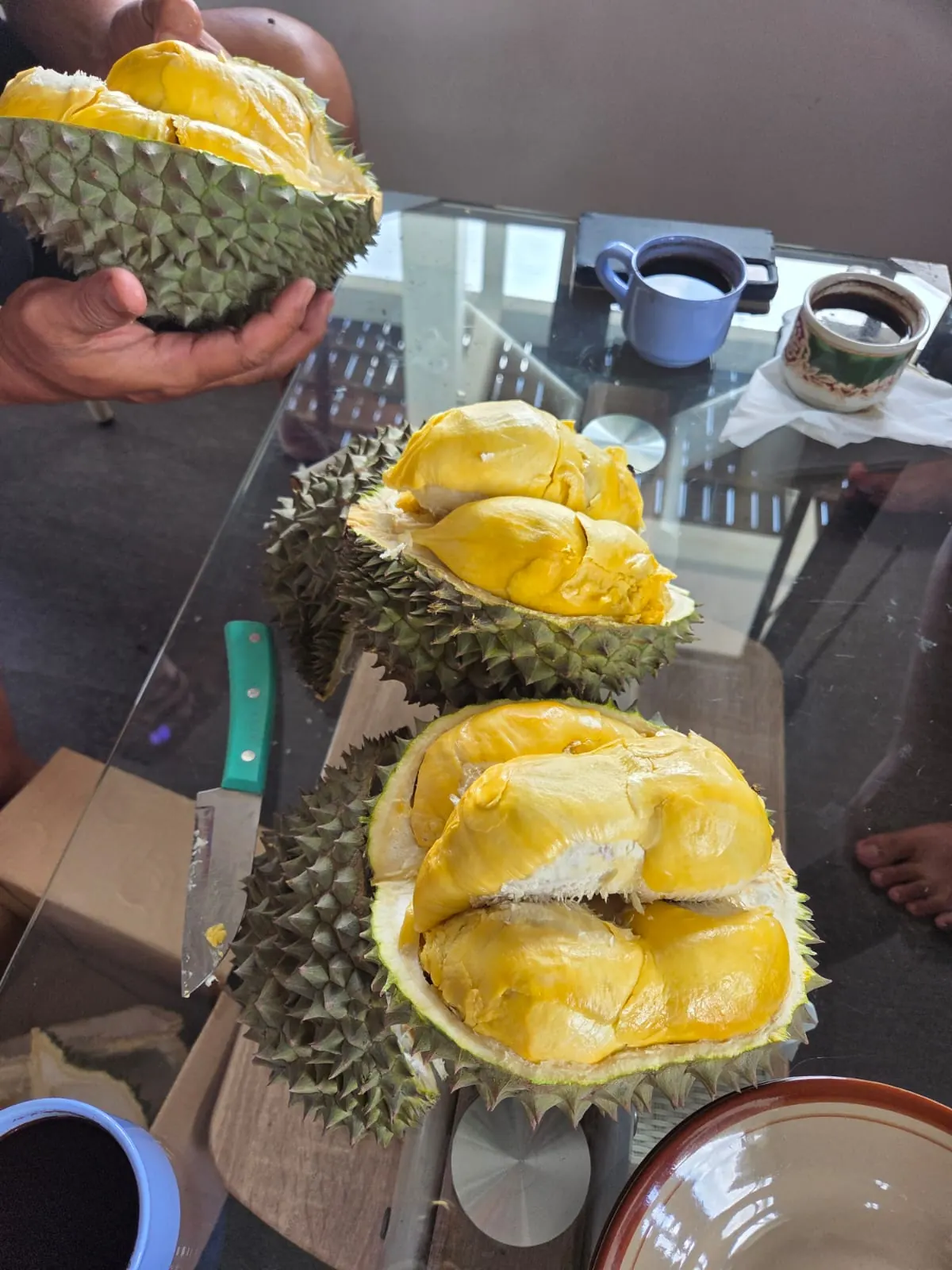 Opened durian showing thick golden flesh